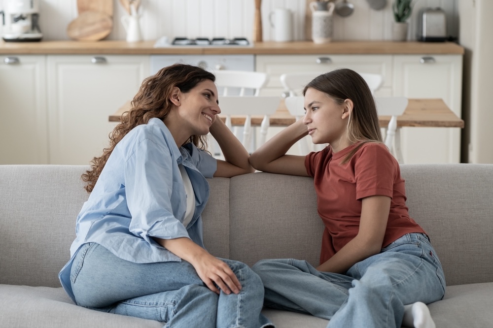 Mother talking to teen daughter about mental health residential treatment